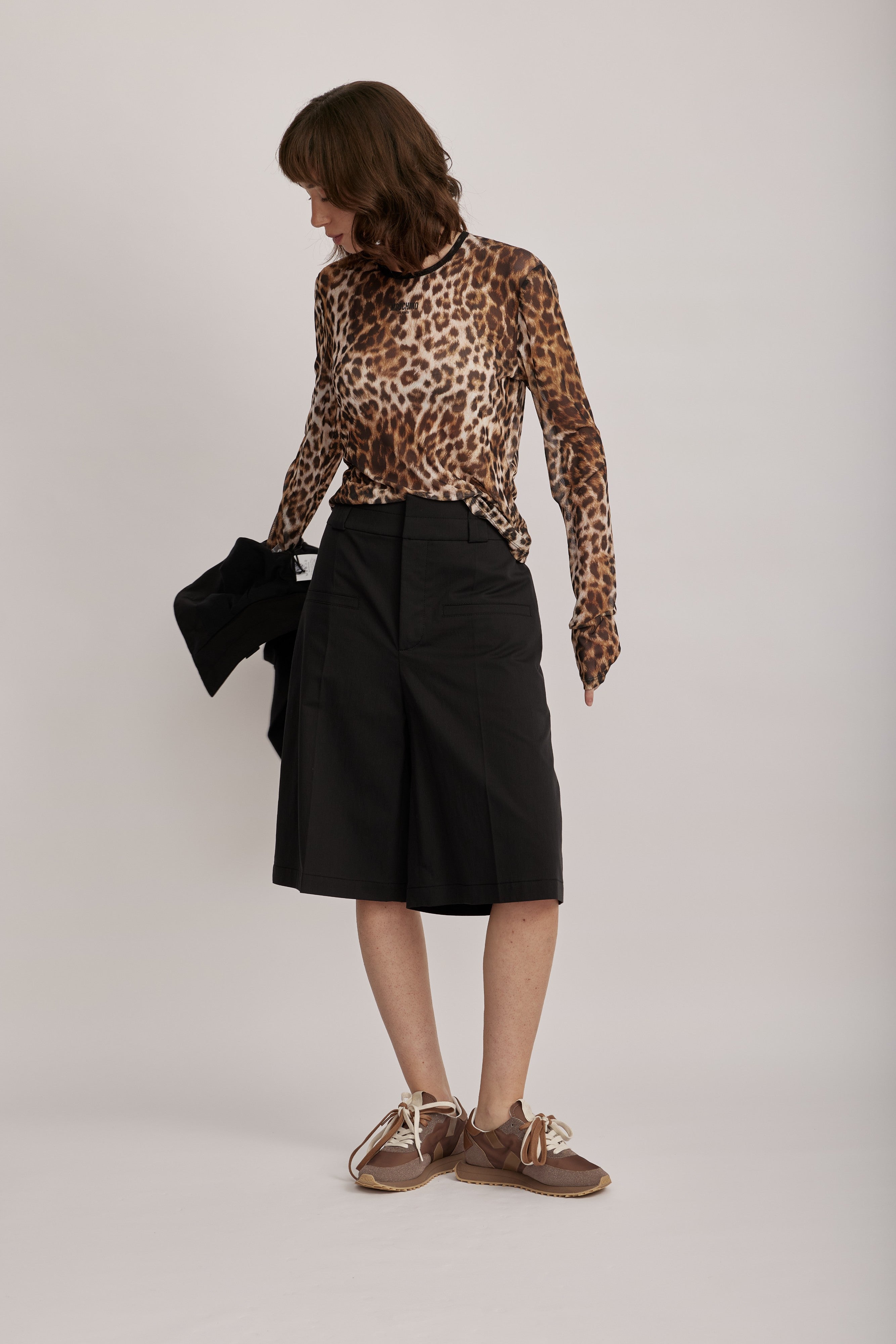 מכנסי ברמודה מליין MOSCHINO JEANS של המותג האיטלקי מוסקינו.גזרה מתרחבת באורך הברך, בצללית A, עם קפלים מודגשים, לולאות לחגורה, וסגירה באמצעות וו ורוכסן נסתר.הרכב: 61% כותנה, 36% פוליאמיד, 3% אלסטןהדוגמנית בגובה 1.75 ולובשת מידה 40 של MOSCHINO