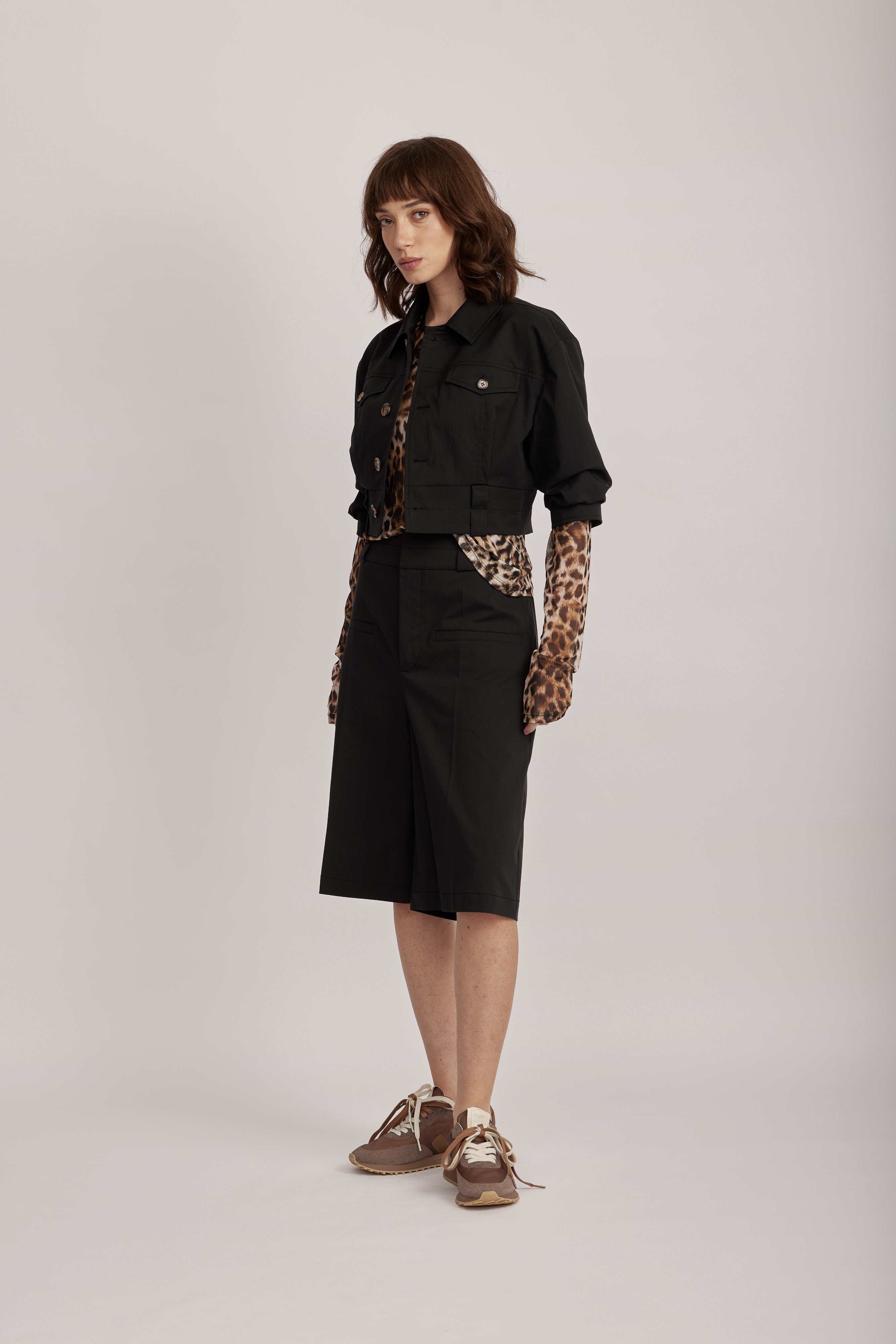 מכנסי ברמודה מליין MOSCHINO JEANS של המותג האיטלקי מוסקינו.גזרה מתרחבת באורך הברך, בצללית A, עם קפלים מודגשים, לולאות לחגורה, וסגירה באמצעות וו ורוכסן נסתר.הרכב: 61% כותנה, 36% פוליאמיד, 3% אלסטןהדוגמנית בגובה 1.75 ולובשת מידה 40 של MOSCHINO