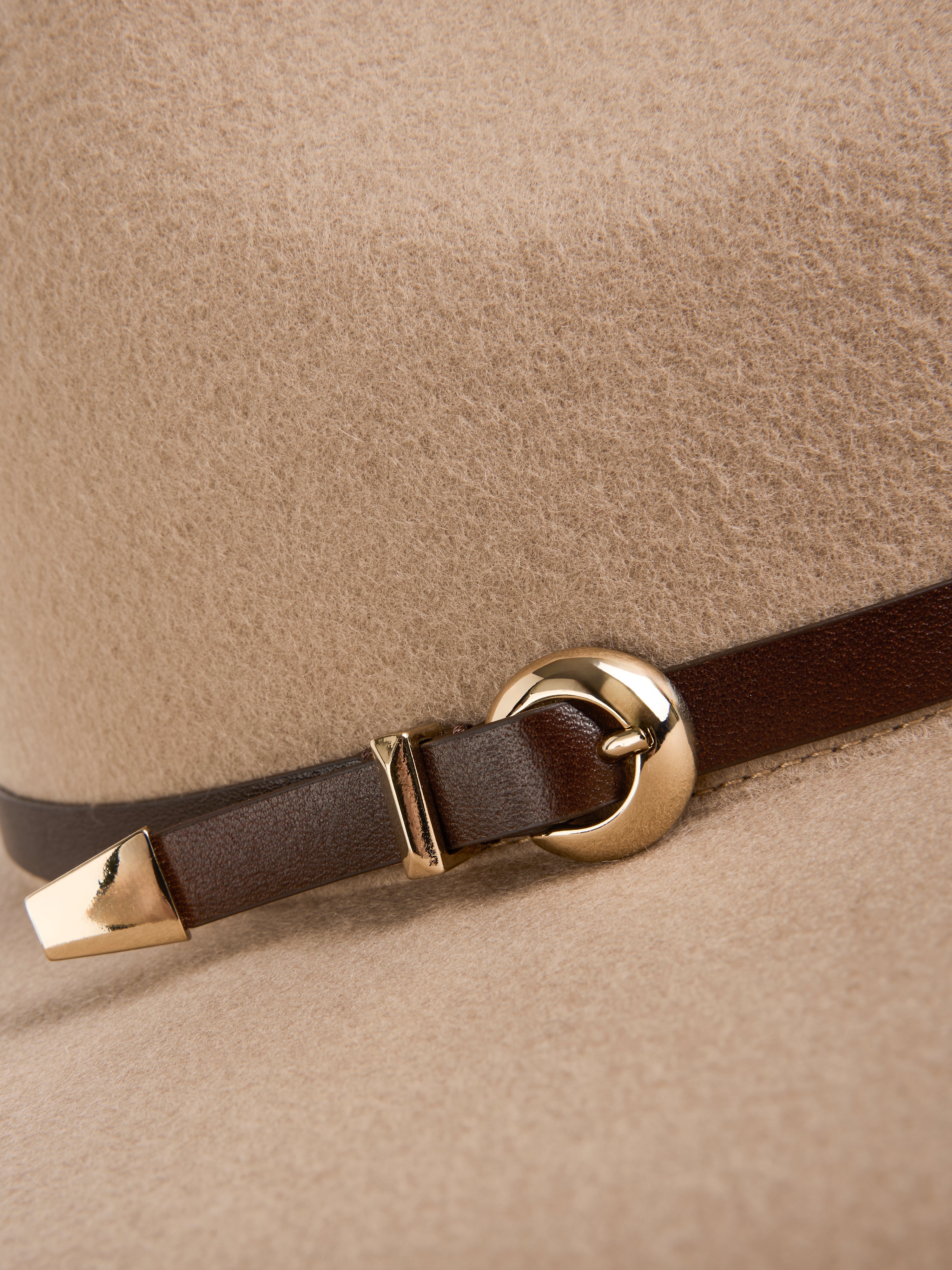 כובע פדורה עשוי צמר רך, מעוטר ברצועת עור ואבזם מתכתי מוזהבהרכב: 100% צמר