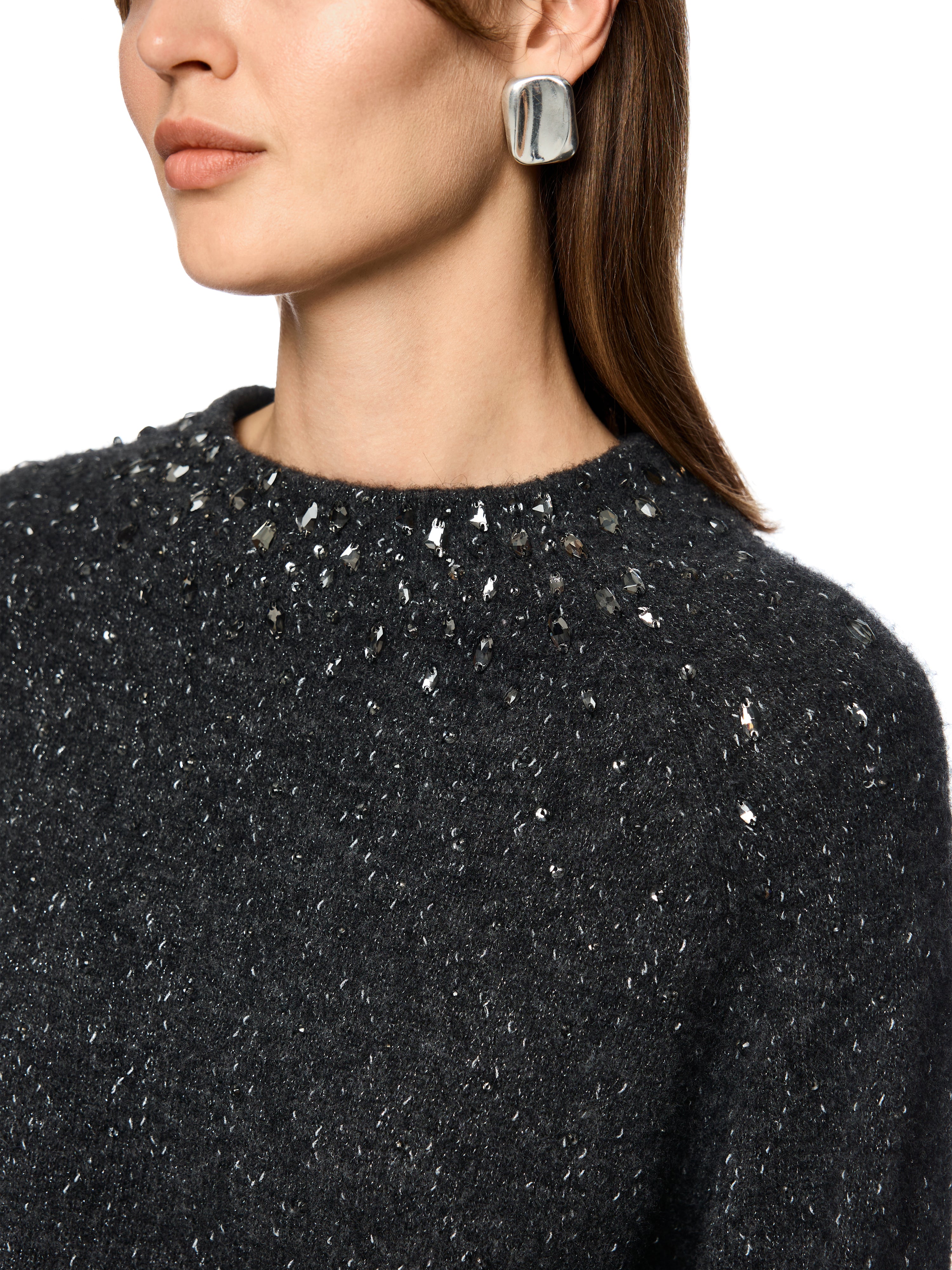 סריג בגוון אפור כהה עם חוטים מבריקים, צווארון גבוה, גזרה רפויה ושרוולים ארוכיםמתאים למראה אלגנטי יומיומי או לאירועים מיוחדיםהרכב בד: 32% פוליאמיד, 27% צמר אלפקה, 27% צמר חדש, 9% פוליאסטר, 5% סיב מתכתיהדוגמנית בגובה 1.79 ולובשת מידה 3 של מארק קיין