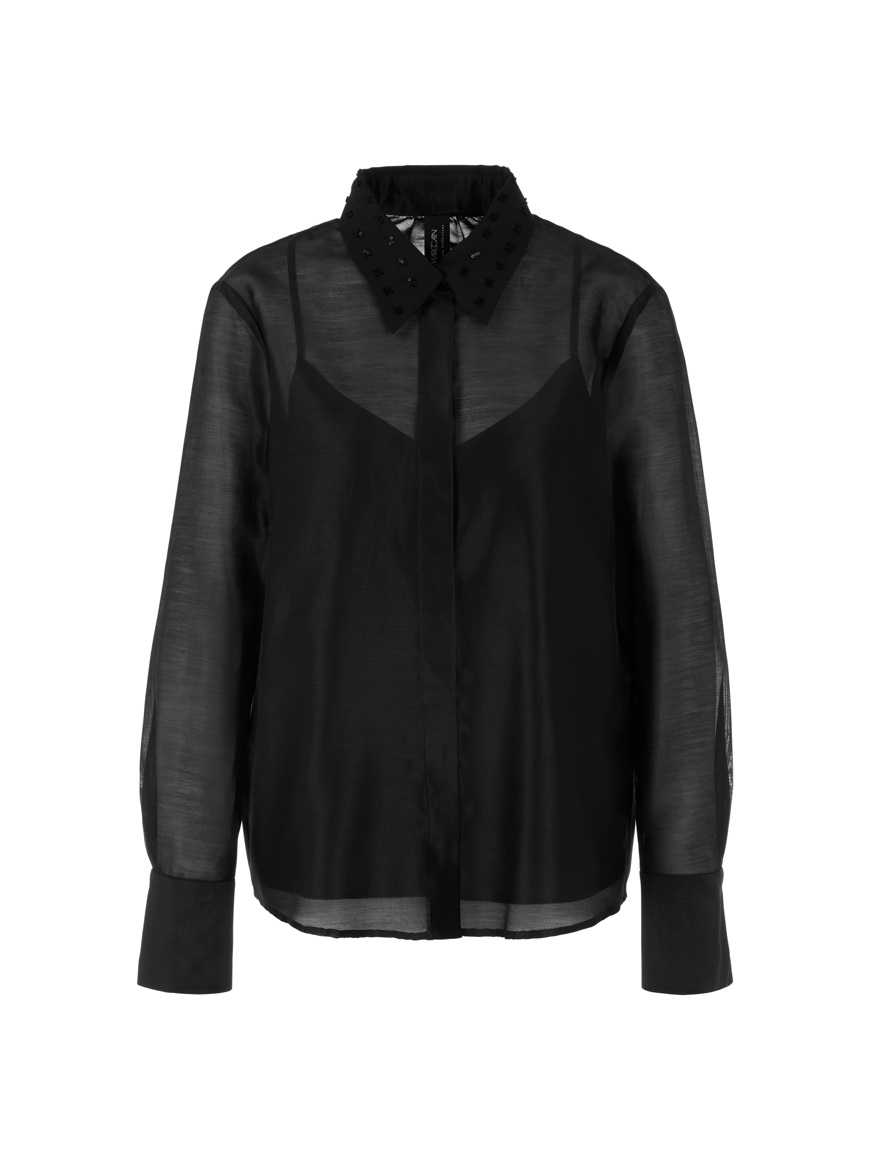 חולצת אורגנזה שקופה עם רקמה עדינה בצווארון, בגזרה רחבה עם תחתית חלקה וחלק שקוף בחלקה העליון.הרכב בד: 79% כותנה, 21% משיהדוגמנית בגובה 1.79 ולובשת מידה 3 של מארק קיין