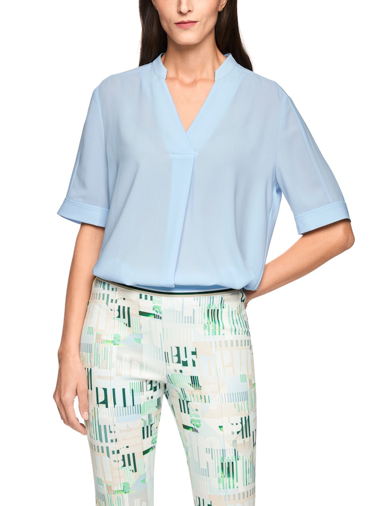 חולצה בגזרה רחבה, מבד קליל וזורם. עם שרוולים קצרים, וצווארון V עם קפל בתחתית המקנה לה צללית ייחודית. הרכב: 100% פוליאסטרהדוגמנית בגובה 1.79 ולובשת מידה 3 של מארק קיין