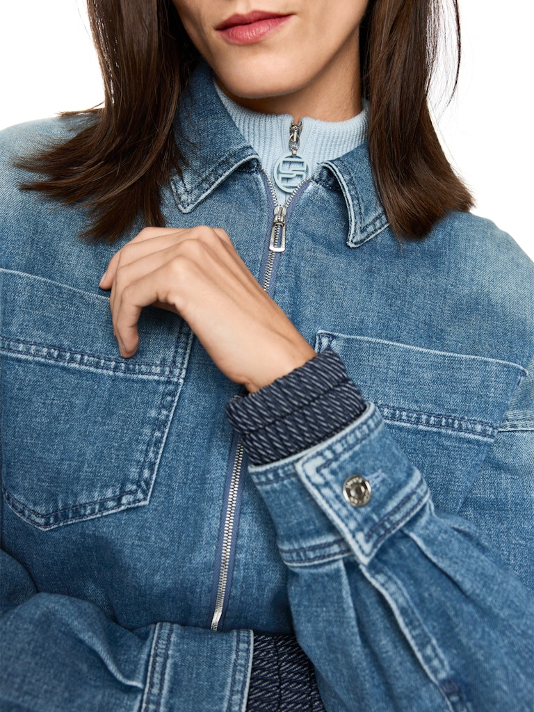 ז'קט ג'ינס באורך קצר ובגזרה נינוחה, בגוון כחול עם שטיפה ייחודית המעניקה לו מראה וינטג' אופנתי. עם צווארון קלאסי, שרוולים ארוכים בסיומת חפתים מכופתרים, כיסי פאץ' חזיתיים, וסגירה באמצעות רוכסן.הרכב: 99% כותנה, 1% אלסטןהדוגמנית בגובה 1.79 ולובשת מידה 3 של מארק קיין