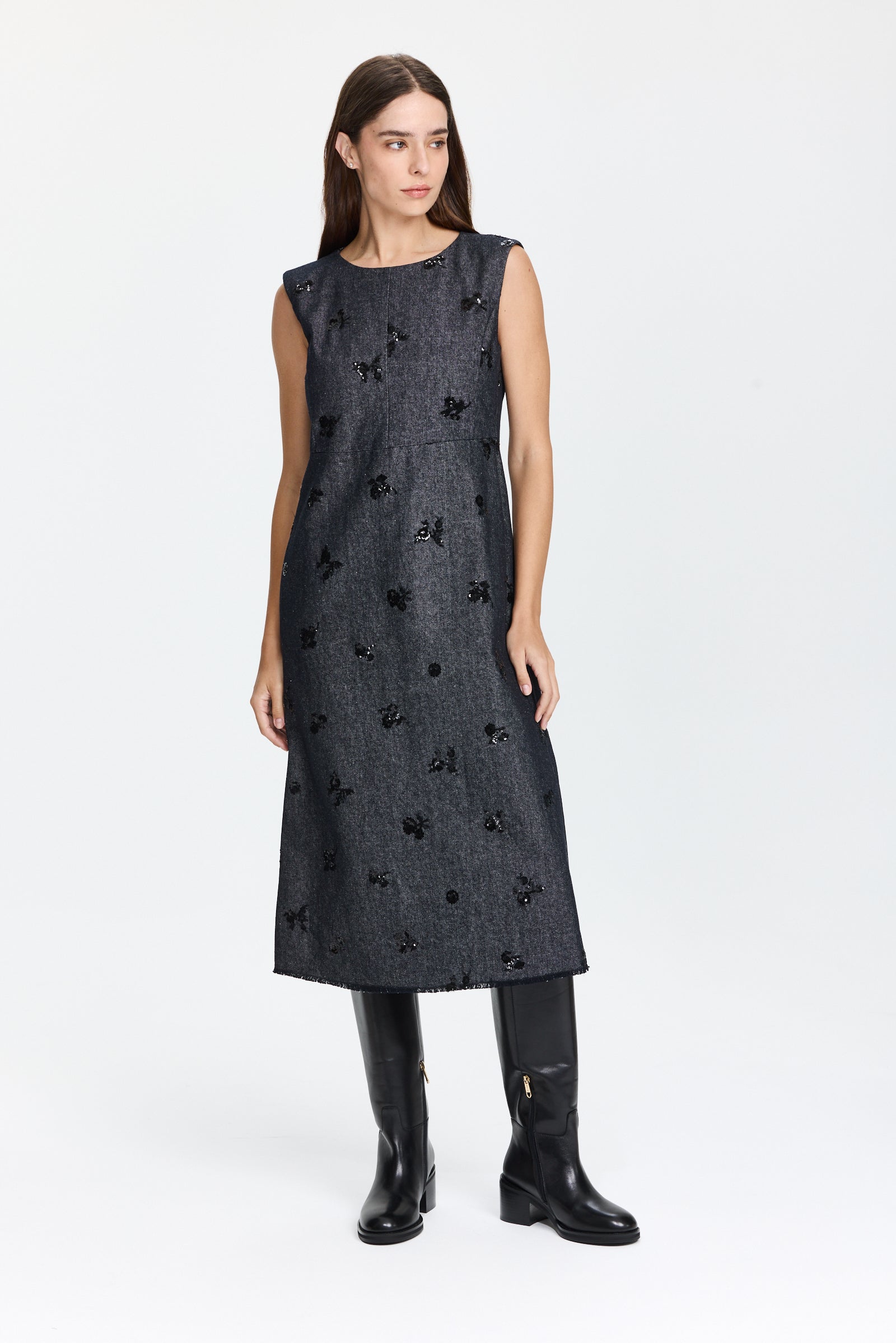 שמלת ג'ינס אלגנטית בגזרה מתרחבת, בצבע כחול כהה עם פאייטים עדינים בחזיתלשמלה חולצה תואמתהרכב: 57% ויסקוזה, 43% פוליאסטרהדוגמנית בגובה 1.75 ולובשת מידה 36 של Luisa Cerano