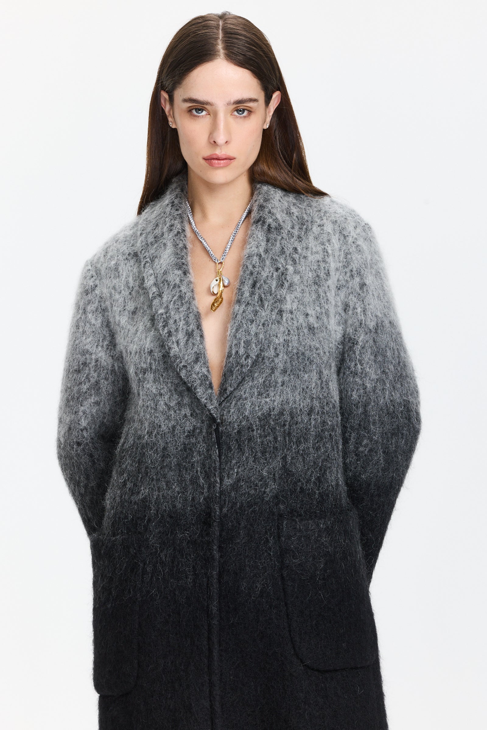 מעיל בגוון אפור-שחור, עם גימור פרנזים ייחודיגזרה רחבה ונינוחה עם שרוולים נפולים וכיסים צדדיים, סוגר בלחצני סנאפ נסתרים.מושלם ללוק חורפי במראה בוהוהרכב: 28% מוהיר, 28% צמר אלפקה, 24% תערובת צמר, 20% פוליאמידהדוגמנית בגובה 1.79 ולובשת מידה 3 של מארק קיין