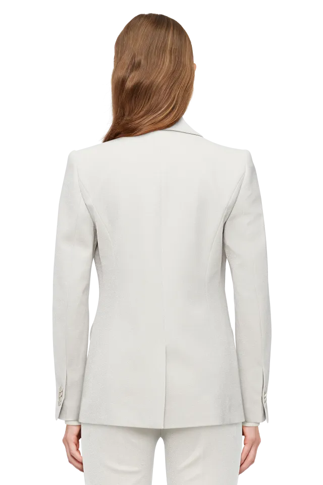 בלייזר מחוייט מבית המותג DRYKORN, עשוי תערובת ויסקוזה איכותית בגימור מנצנץ, לתחושת נוחות ורכות. גזרת סלים ישרה וקלאסית, עם צווארון דש, שרוולים ארוכים בסיומת חפתים מכופתרים, בטנה דקה, כיסים קדמיים עם לשונית, וסגירה באמצעות כפתור אחד.הרכב: 69% ויסקוזה, 23% פוליאסטר, 6% פוליאמיד מתכתי, 2% אלסטןהדוגמנית בגובה 1.78 ולובשת מידה 2 של דרייקורן