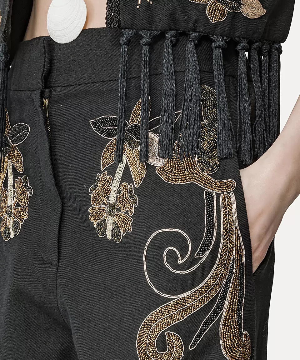 מכנסיים מחוייטים עם עיטור חרוזים הרכב: 60% כותנה, 40% צמרהדוגמנית בגובה 1.77 ולובשת מידה 40 איטלקית (מידה I של פורטה פורטה)