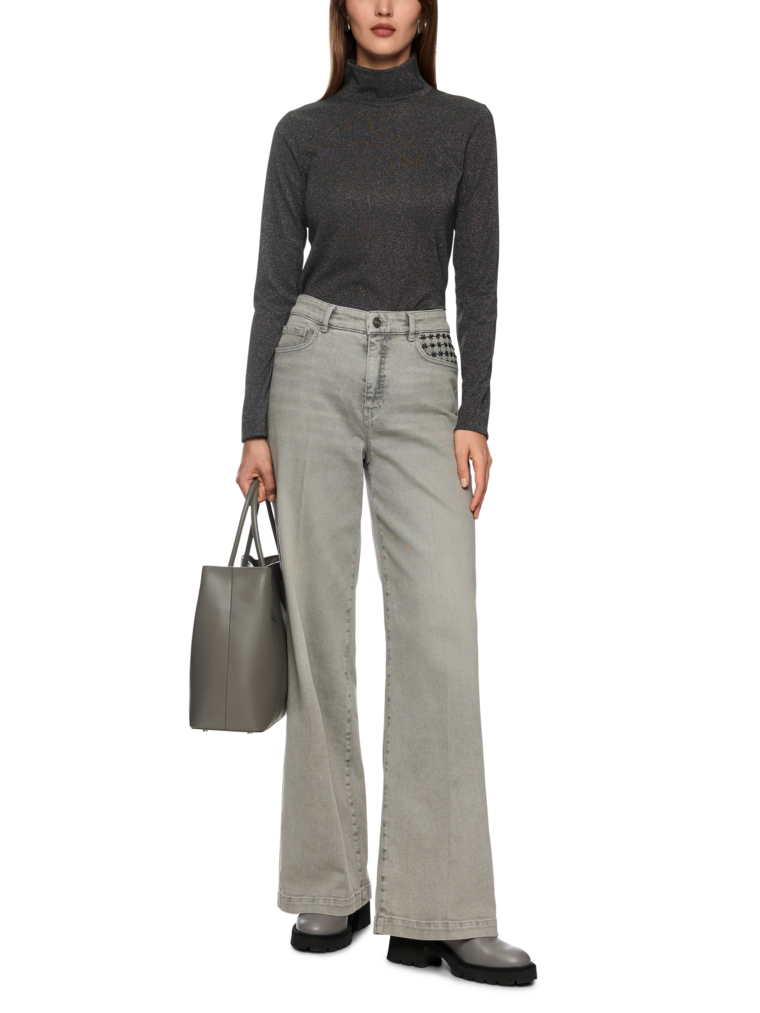 חולצה עם שרוולים ארוכים, לורקס מנצנץ וצווארון גבוה. גזרה צמודה ובד גמיש, בגוון אפור כהההרכב בד: 66% פוליאסטר, 17% סיב מתכתי, 15% פוליאמיד, 2% אלסטןהדוגמנית בגובה 1.79 ולובשת מידה 3 של מארק קיין