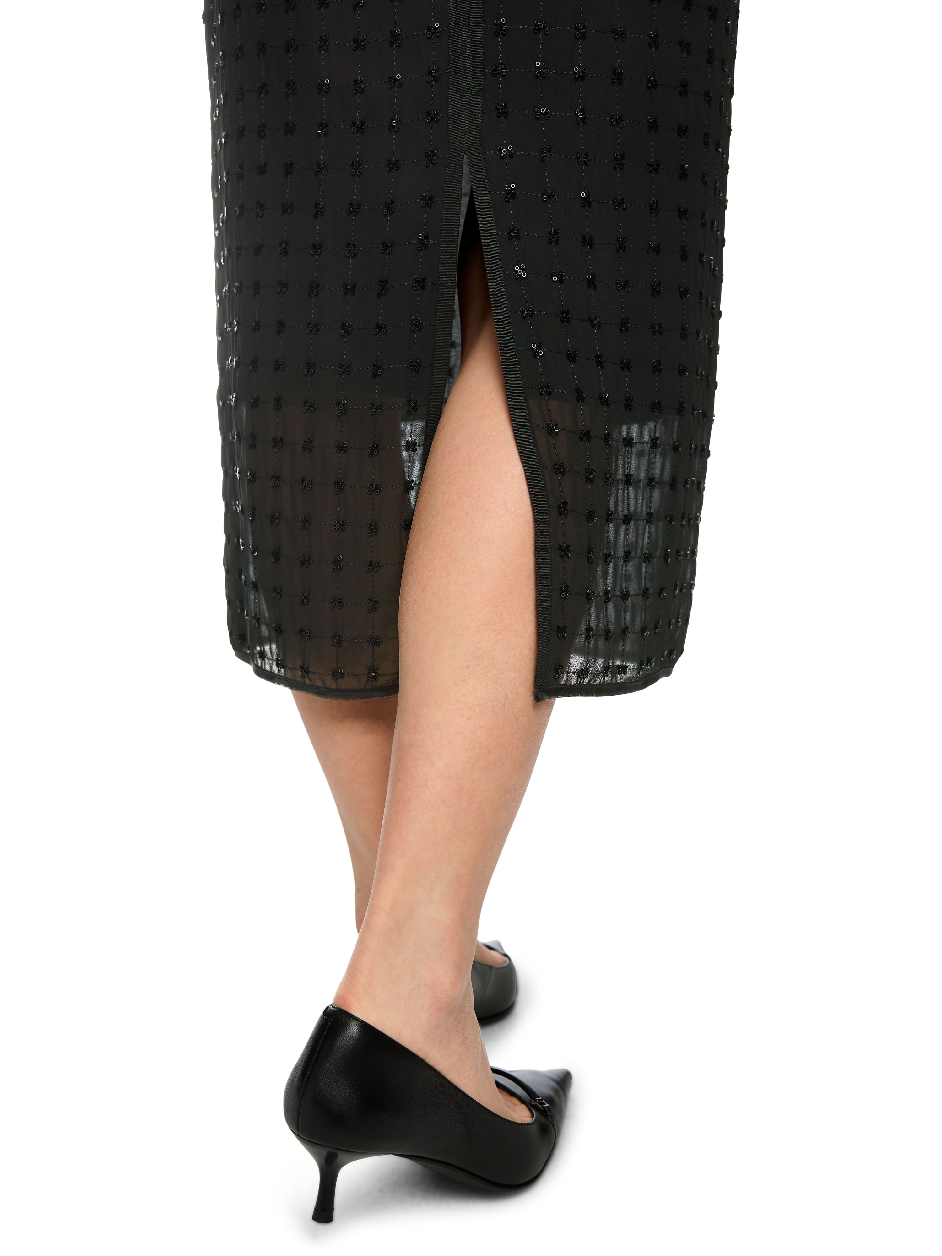 חצאית שחורה ישרה באורך מידי, רקומה כולה בפאייטים מבריקיםכוללת רוכסן נסתר ושסע אחוריהרכב בד: 100% פוליאסטרהדוגמנית בגובה 1.79 ולובשת מידה 3 של מארק קיין