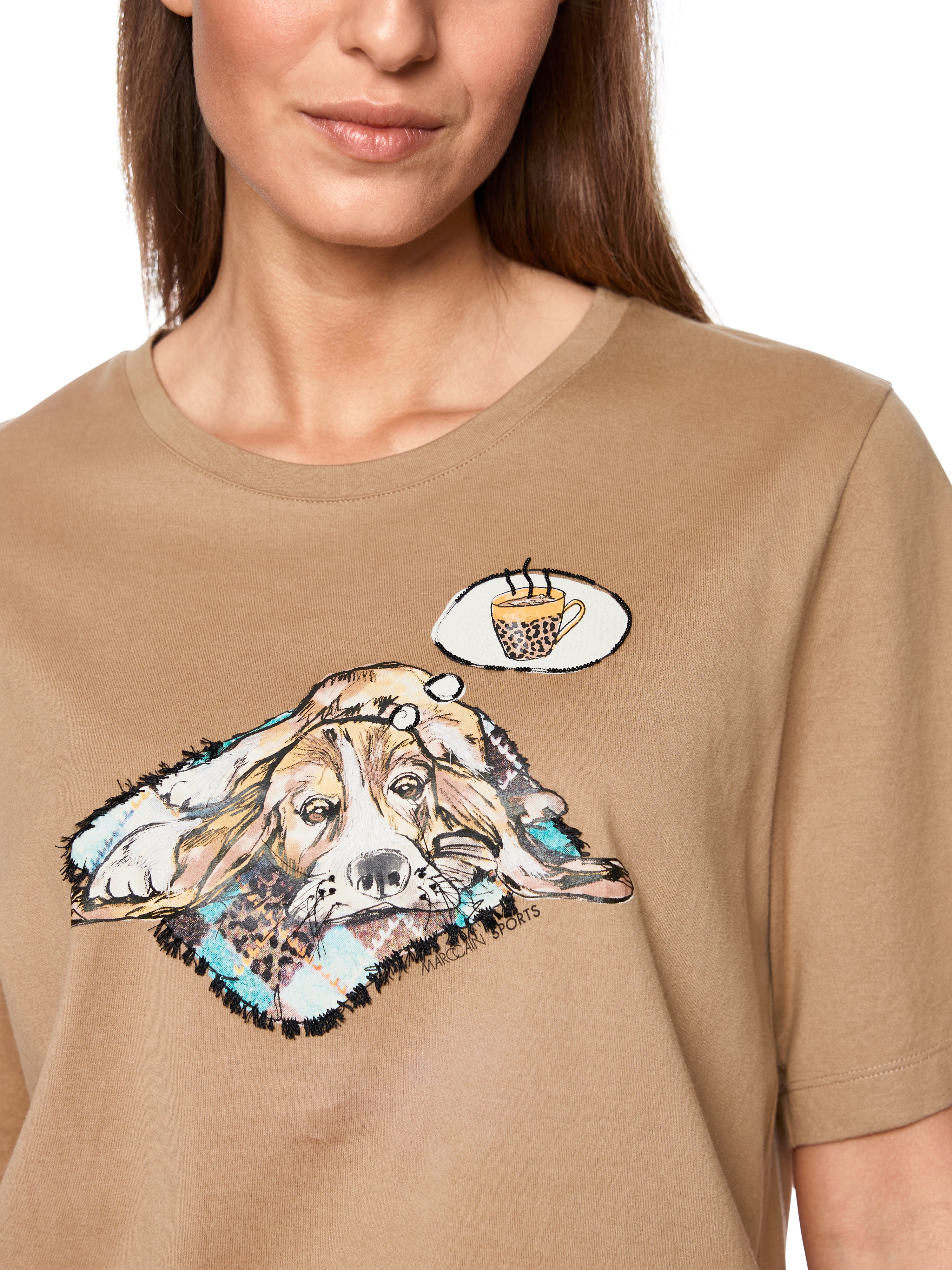 חולצת טי קצרה בצבע חום בהיר בגזרה רפויה ונעימהמעוטרת בהדפס כלב חמוד עם אבנים מנצנצות ופרטים עדיניםהרכב בד: 100% כותנההדוגמנית בגובה 1.79 ולובשת מידה 3 של מארק קיין